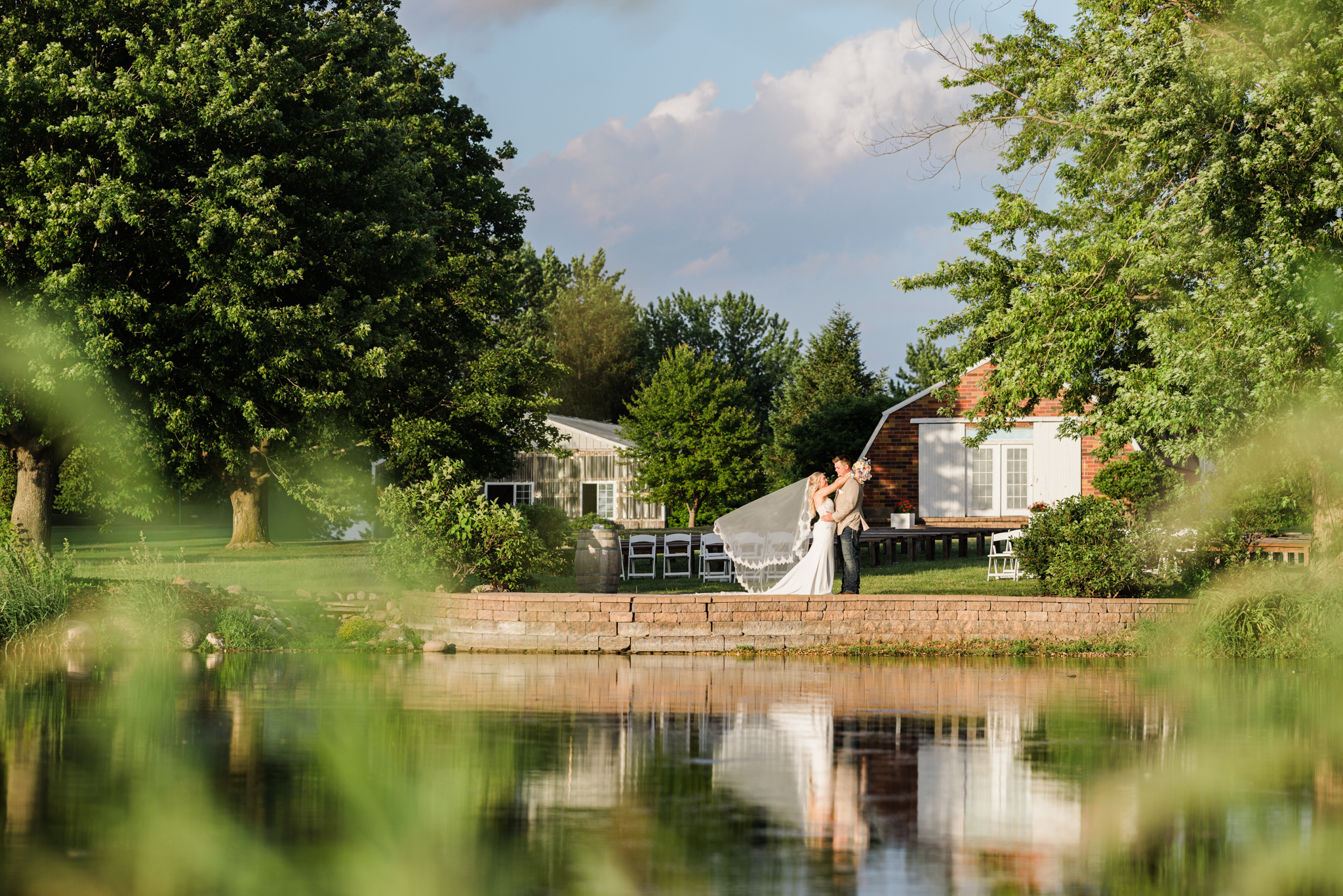 The Barn at Brophy Creek Farm wedding venue in DeWitt, Iowa surrounded by cornfields and summer greenery